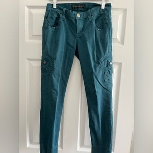 Teal colored low rise pants with hip pockets and studded details, size 4!